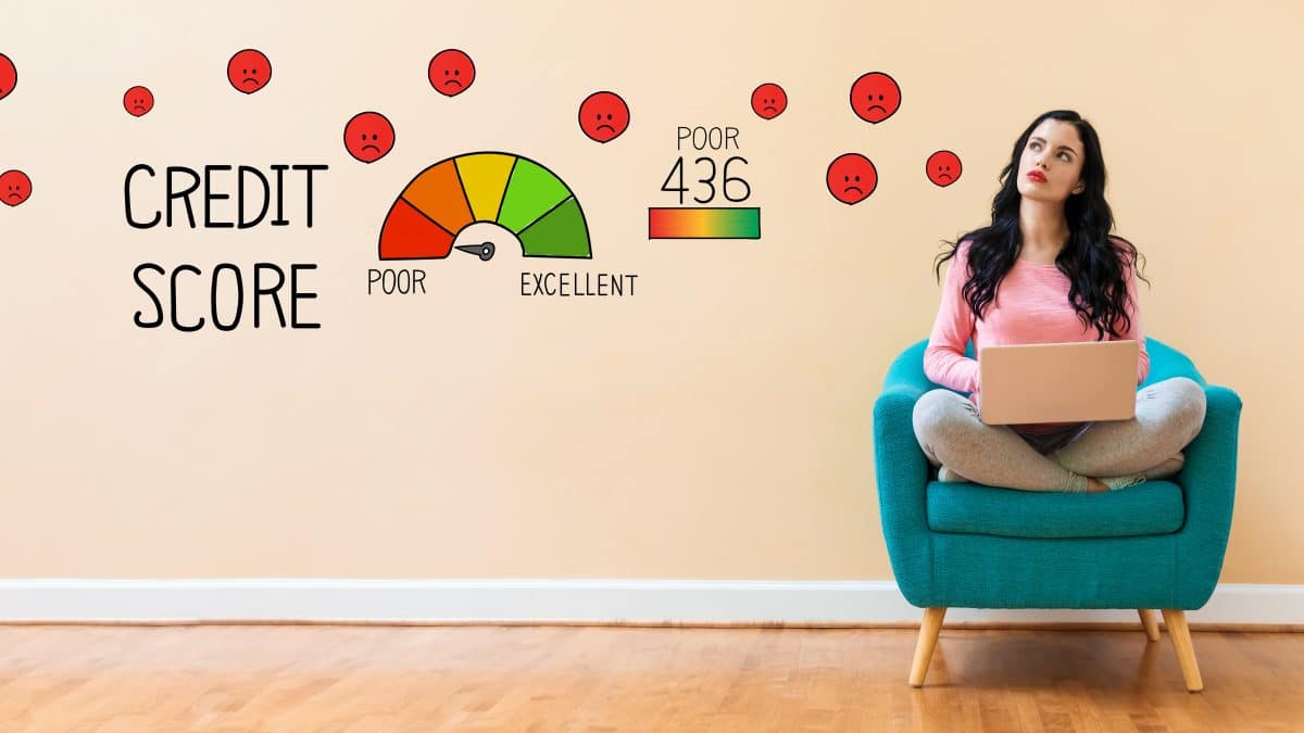 An image of a woman sitting in a chair with illustrations pointing to a decreased credit score.