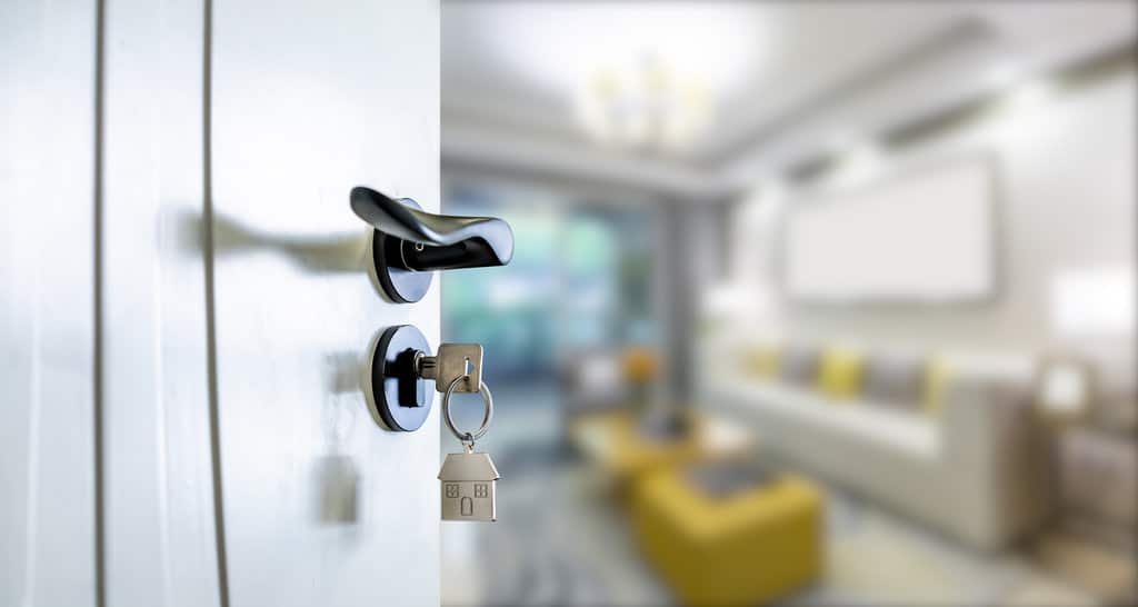 An image of an opened door with a key in the lock.