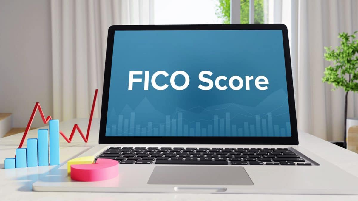 An image of a laptop with the term "FICO score"