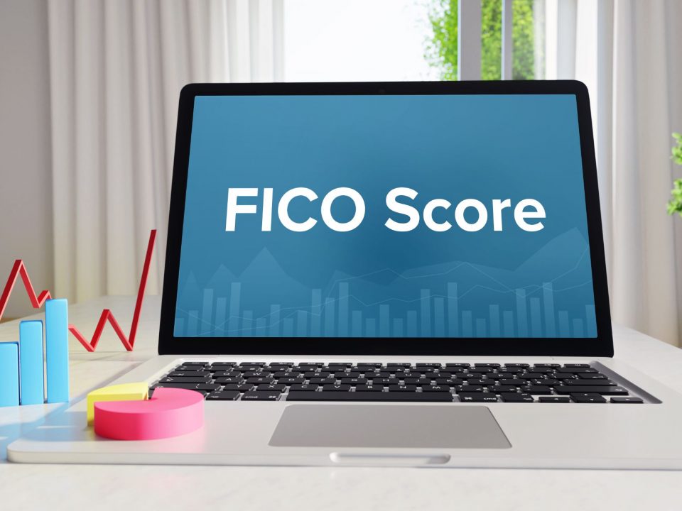 An image of a laptop with the term "FICO score"