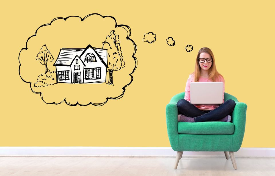 An image of a woman working on her laptop with a dream bubble above her head picturing an illustrated house.