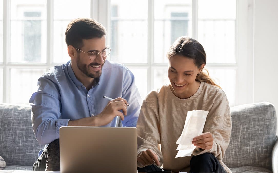 A happy couple doing their finances together.