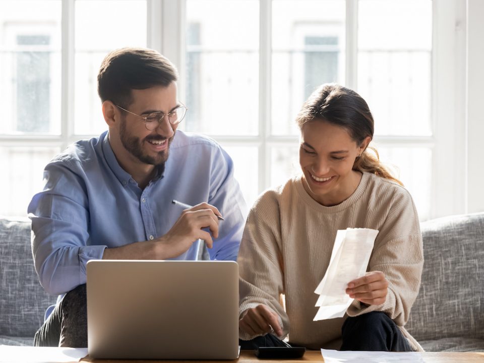 A happy couple doing their finances together.