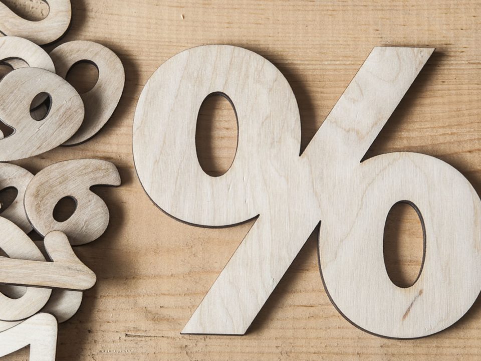 A wood cutout of a percentage sign.