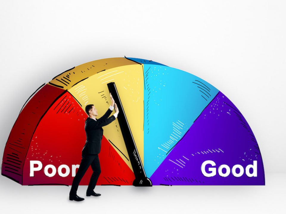 An image of a well dressed man pushing a gauge on a credit score graph.