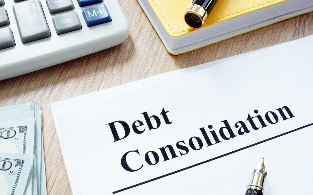 An image focused on a "Debt Consolidation" as the title on a piece of paper.