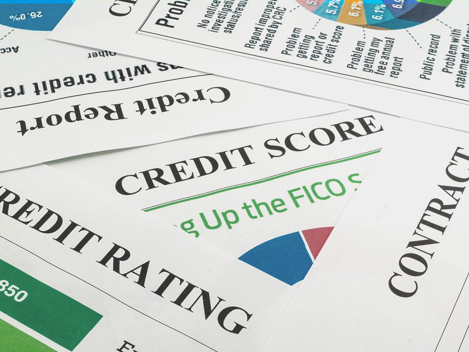 A series of credit information lie in a pile.