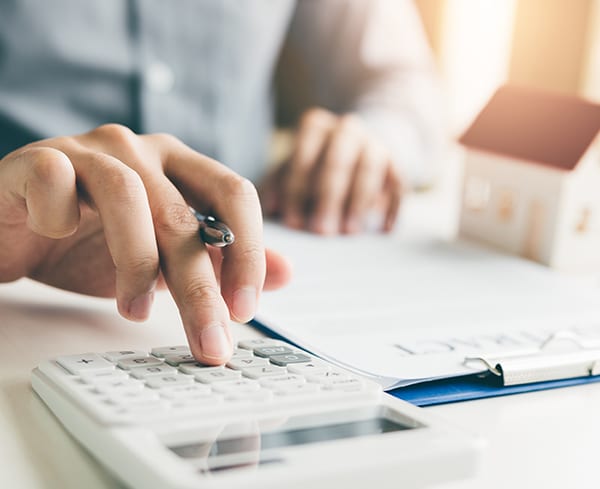 An image of a person doing calculation on a calculator.